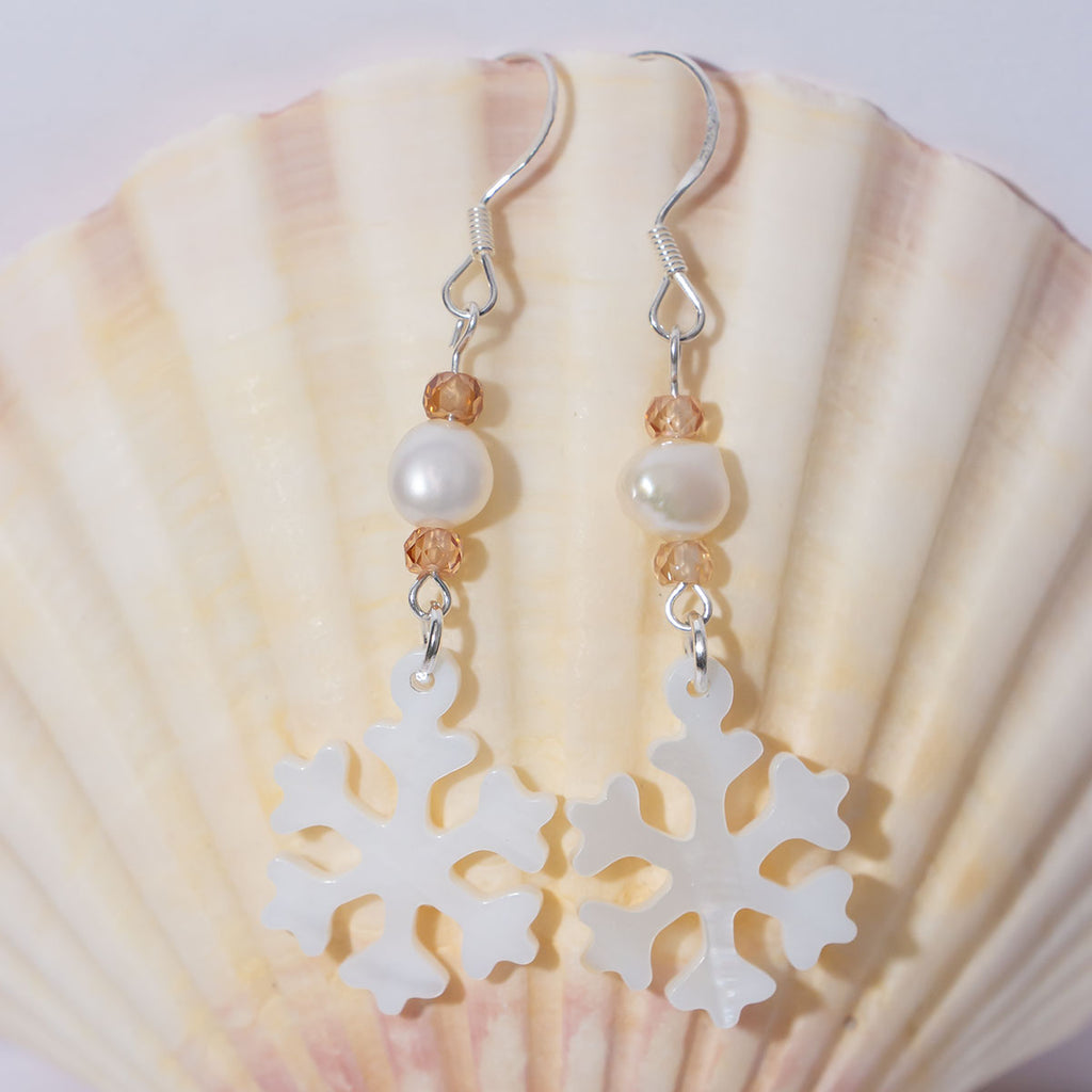 A snowflake on a South Pacific island, imagine that and this pretty carved mother of pearl snowflake has a tiny sparkling mocha coloured CZ bead as a highlight so dream on wearing our newest earring style.