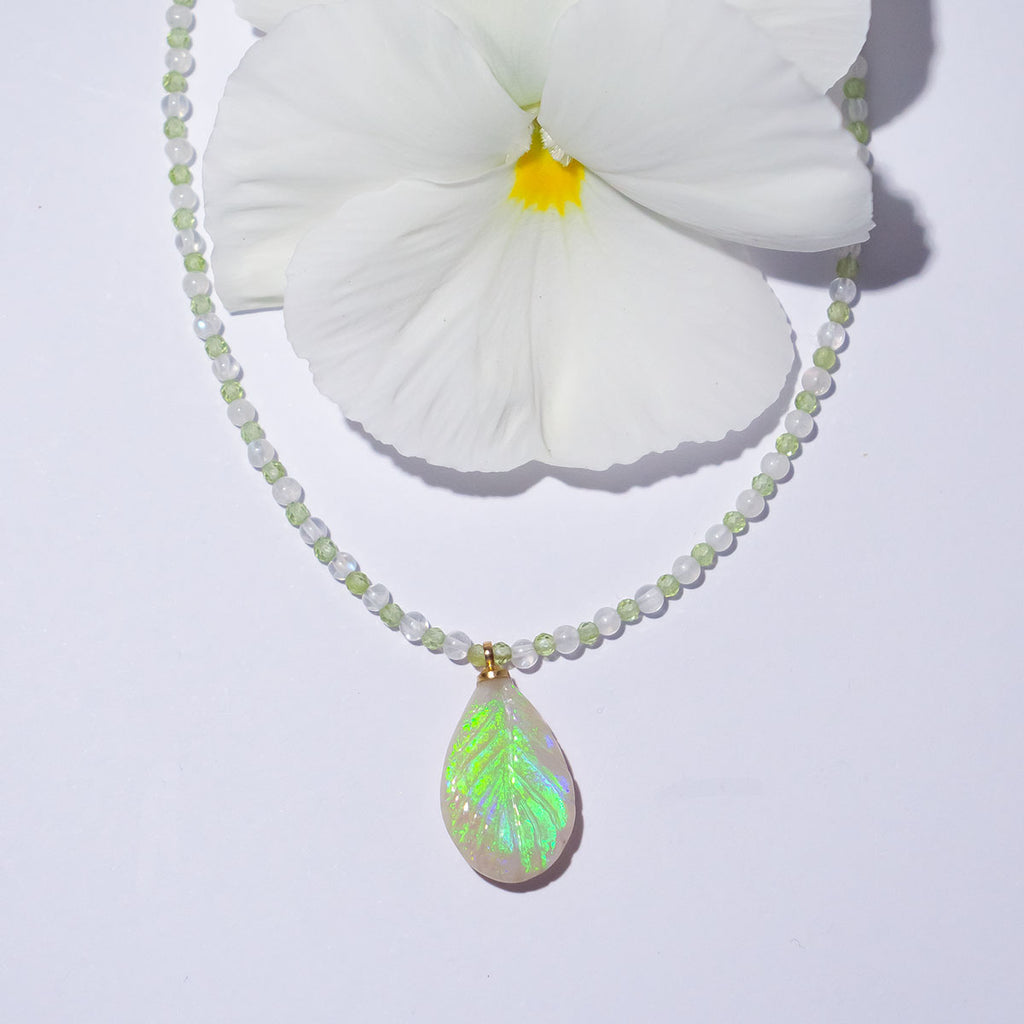 The enchanting soft green flashes of colour in this stunning opal leaf pendant are perfectly&nbsp;complimented by the delicate green of peridot and the magical shimmer of moonstone.