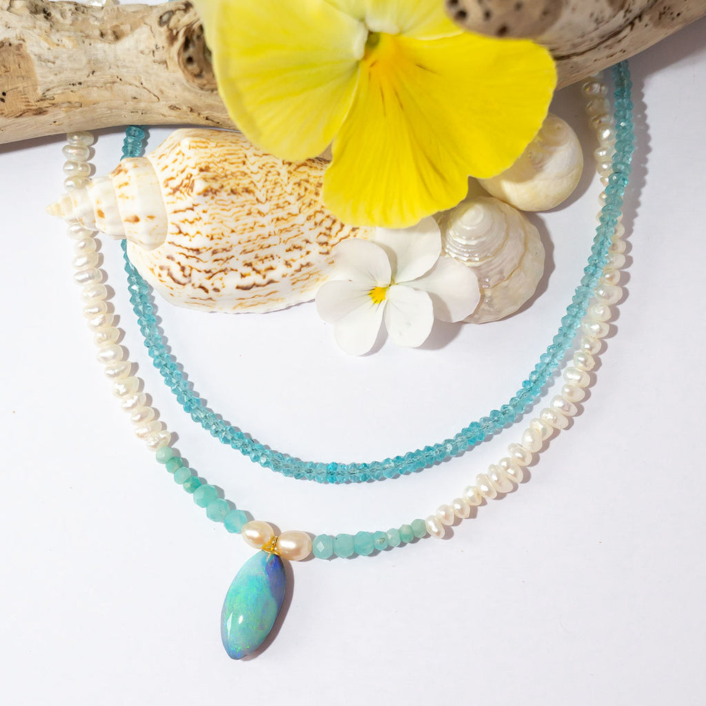 Tiny lustrous Baroque pearls with a pale blue pond of Amazonite beads, the centrepiece is a gorgeous swirl of sea blue Australian opal, a pearl necklace that has the calm and colours of a South Pacific island.