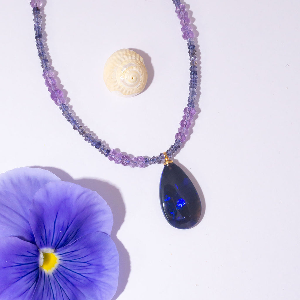 With flashes & swirls of deep purple & darkest blue colour play this magical opal pendant is complimented beautifully by shimmering amethyst & iolite beads.