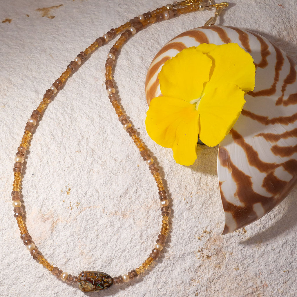 This golden toned gemstone necklaces features luminous citrine & andalustie beads and features a enchanting Australian matrix opal bead with flecks of gold &amp; green colour play.