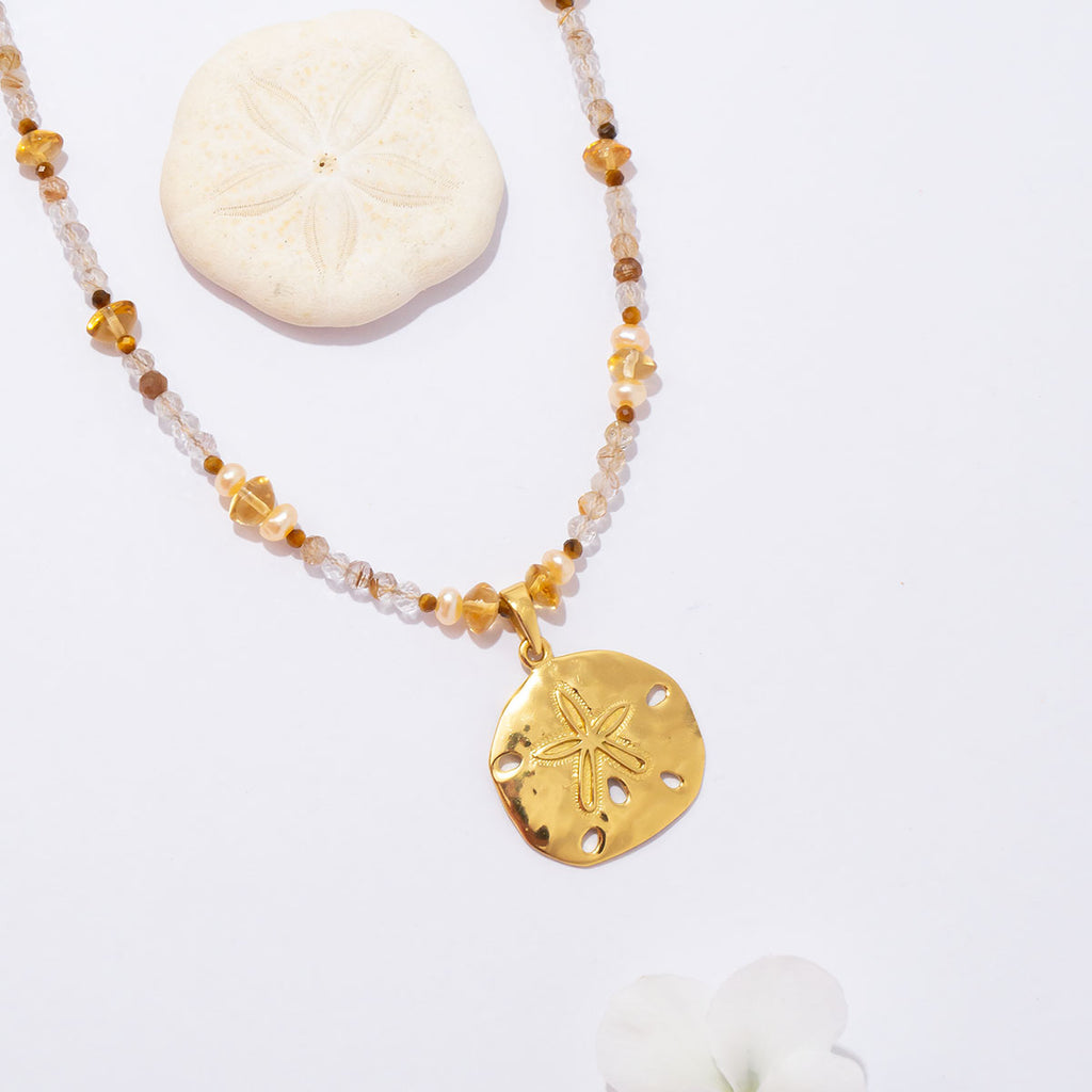 A perfect golden sand dollar set amongst sparkling golden rutile. This is a gorgeous & glowing Summer necklace.