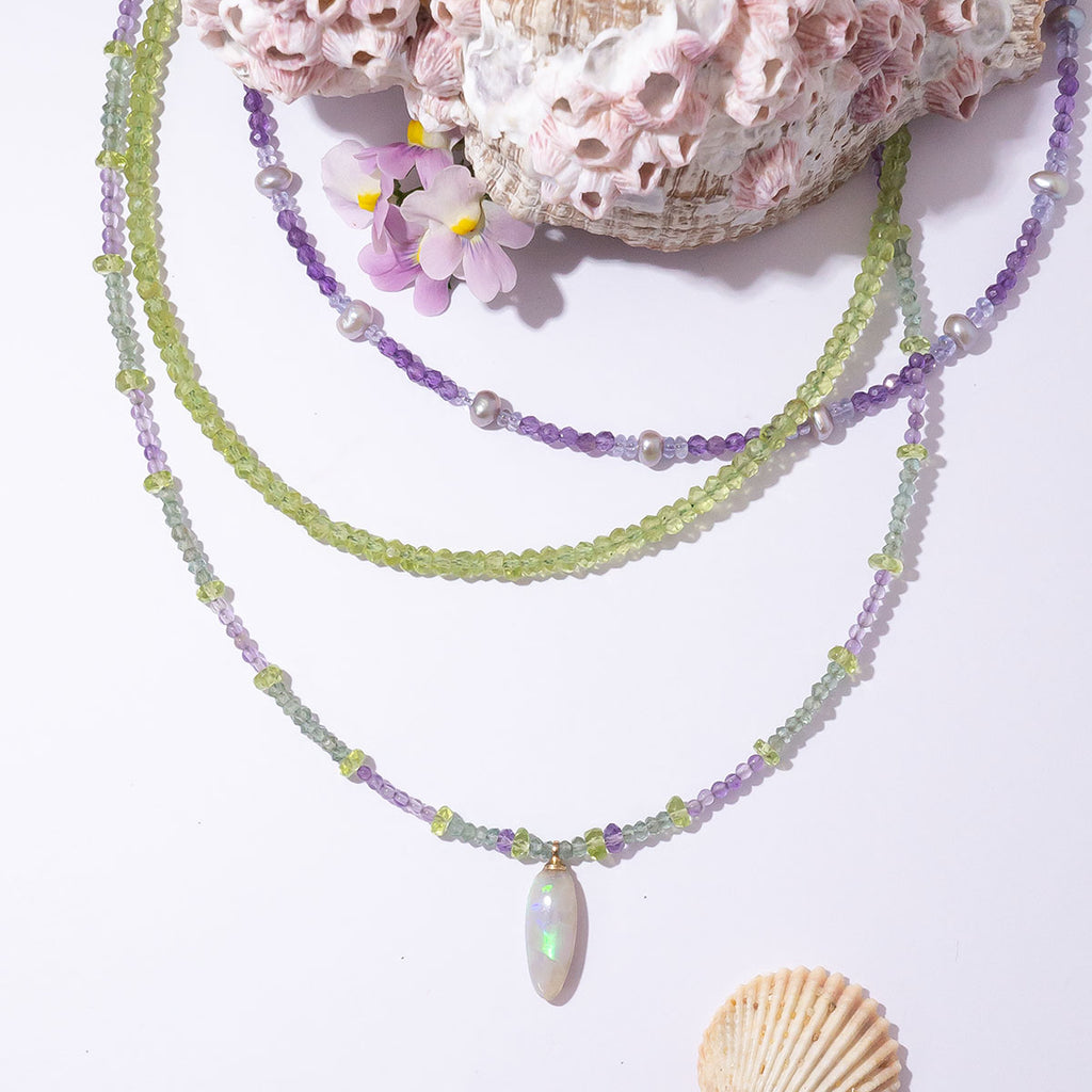 With soft shades of leaf green and periwinkle this delicate gemstone necklace is reminiscent of a beautiful blooming Hydrangea.