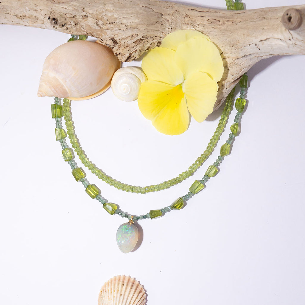 The gorgeous warm spring green of peridot, the shimmering sparkle of green diamonds and an enchanting Lightning Ridge Semi Black Opal come together to make a truly exception necklace.