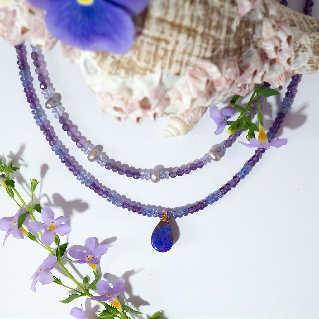 This magical pendant sparkles with blue flashes in a beautiful purple pool of opal. The stunning combination of amethyst & tanzanite is the perfect reflection of the opals shimmering colours.