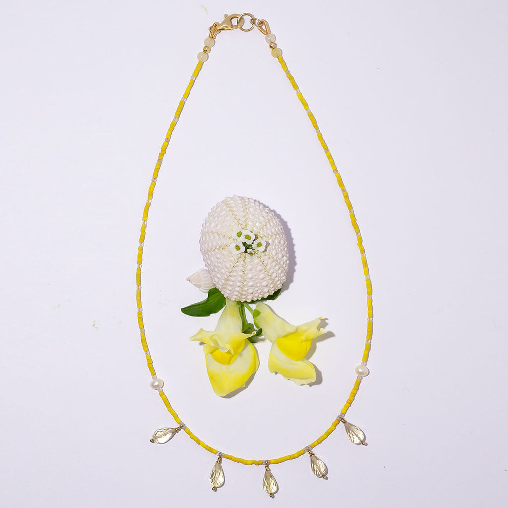 This delicate necklace shines bright with its glorious bright yellow hue.