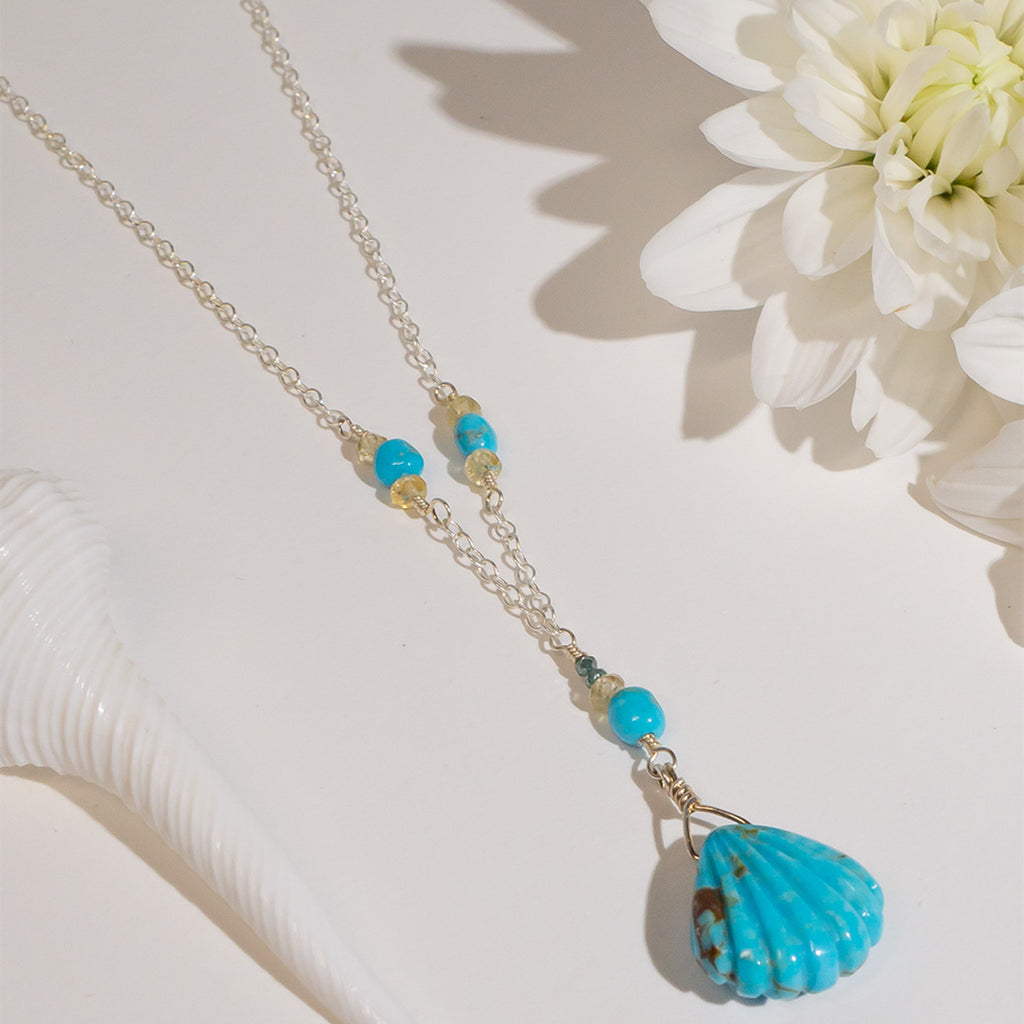 The perfect style for lovers of the sea. This beautiful handmade necklace features a delicate carved turquoise scallop shell pendant.