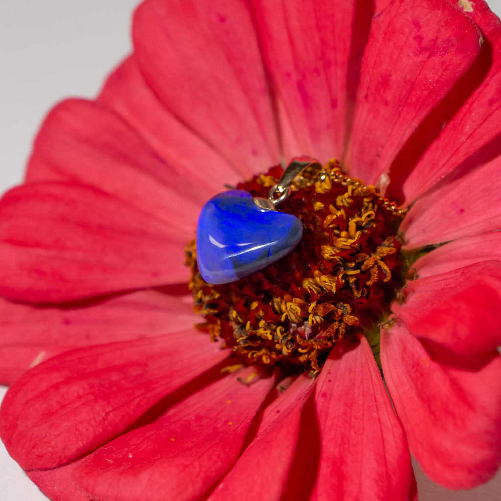 A gorgeous Australian black opal heart pendant, as dark as the night sky on one side, the front is very bright blue with a pool of clear blue crystal at the base, quite magical.&nbsp;