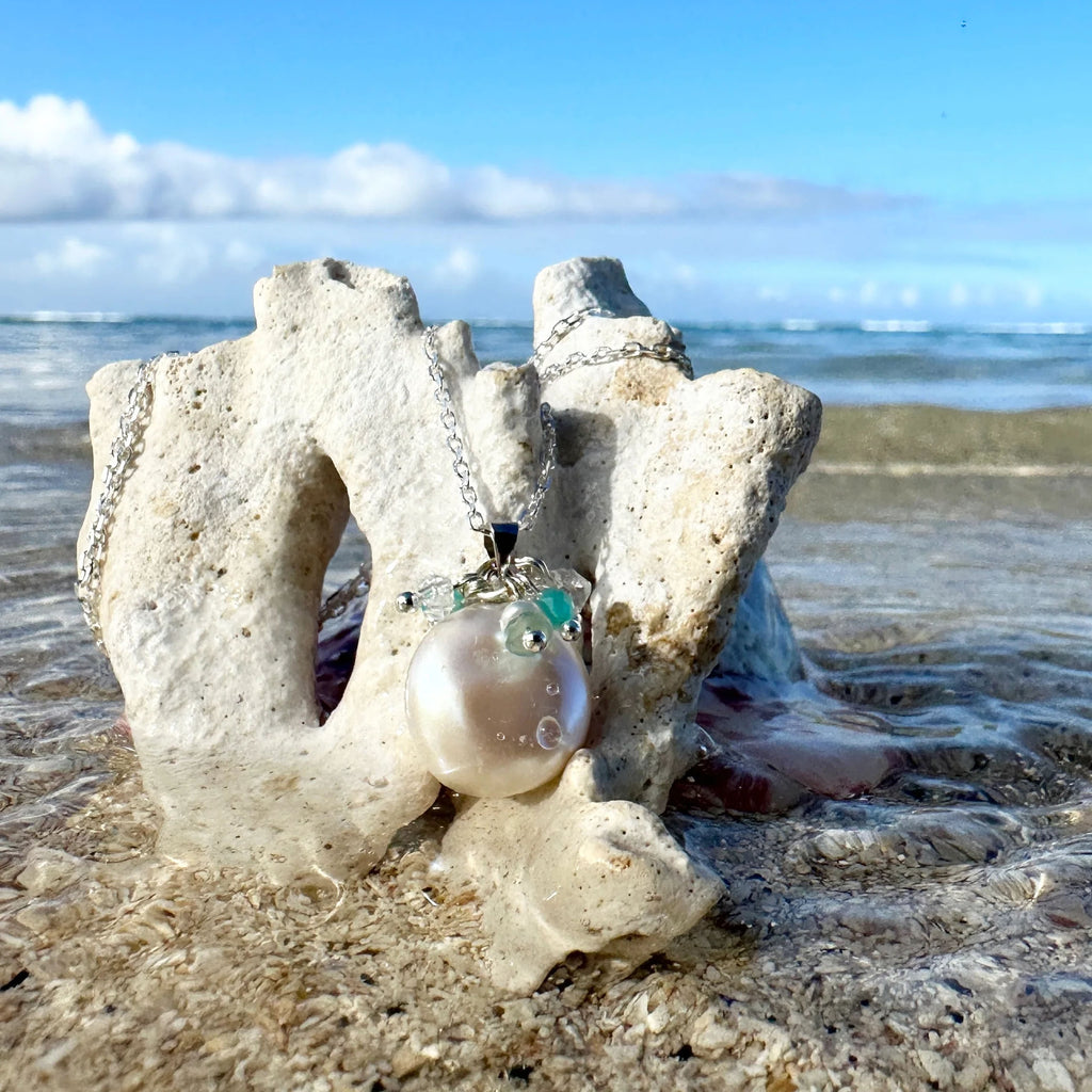 A spray of seawater, silver, aqua blue and a lustrous pearl, necklace has the feel and calm of the tropical island waves washing to shore.